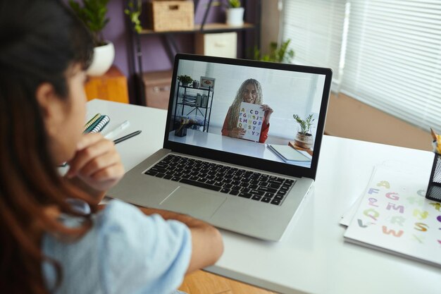 attending-online-learning-session-with-tutor-laptop_274689-54358